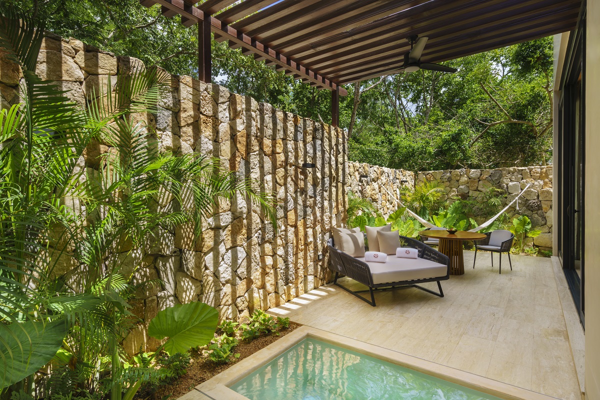 Poolside loungers creating a relaxed garden oasis at Hacienda Xcanatun, Angsana Heritage Collection.